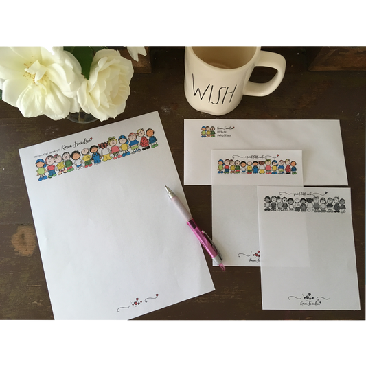 Samples of stationery and notepads make with colored clipart on a table with roses, pink pen and tea cup.